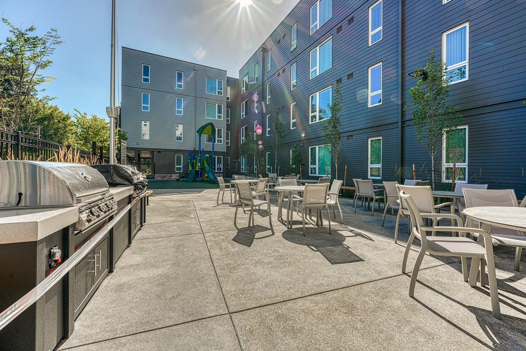 A sunny day at the outdoor seating area of a modern apartment complex.