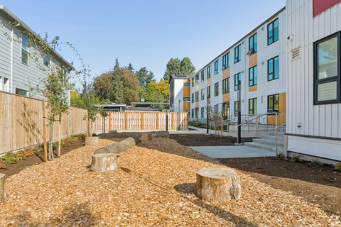 A modern building with a white exterior and a garden in front.