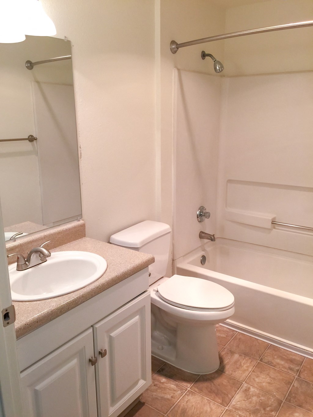 a bathroom with a toilet and a sink and a bath tub
