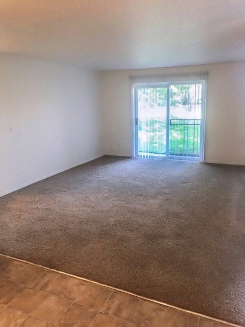 an empty living room with a sliding glass door