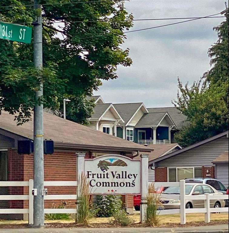 a fruit valley commons sign in front of a row of houses