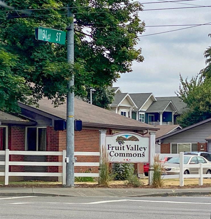 a street sign in front of the fruit valley communities sign