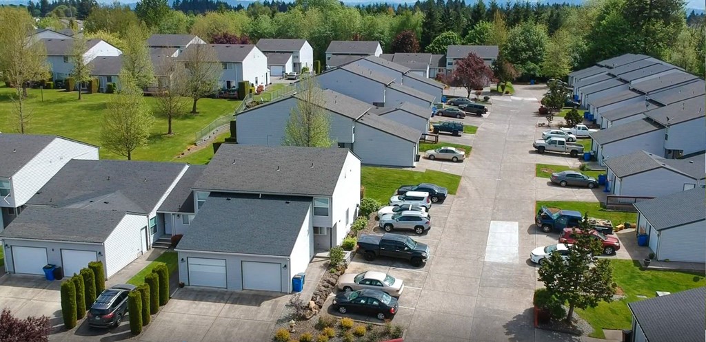 an aerial view of a neighborhood of houses with cars parked