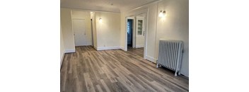 an empty living room with a radiator