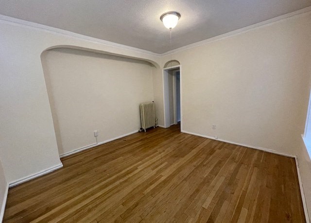 an empty living room with white walls and a wood floor