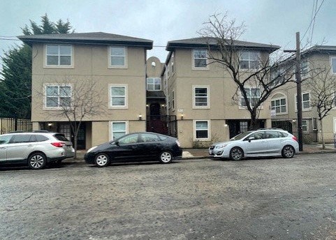 three cars parked in front of an apartment building