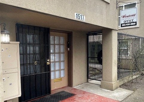 a building with two doors and a sign for an office