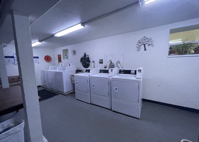 a laundry room with four washing machines in it