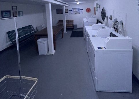 an empty laundry room with washing machines and sinks