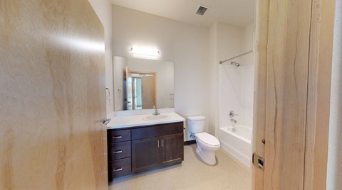 A bathroom with a sink, toilet, and bathtub.