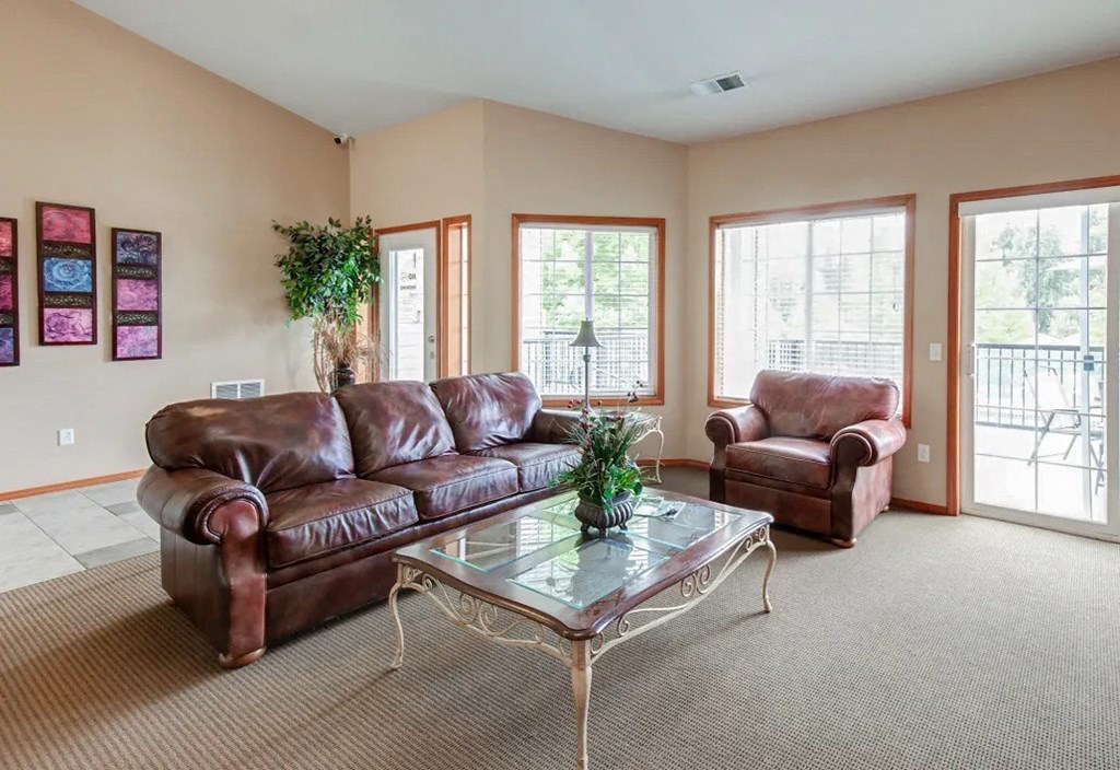 a living room with a leather couch and a coffee table