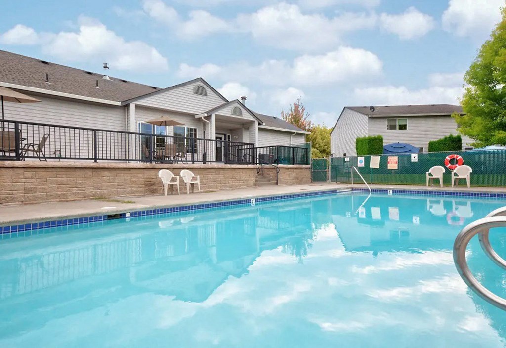 the swimming pool at our apartments with a house in the background