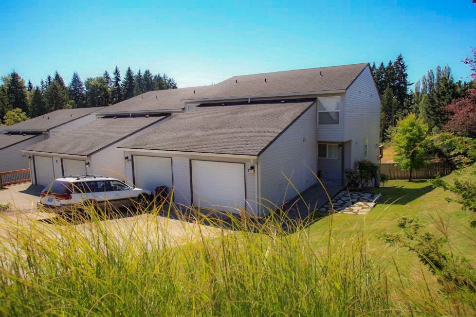a white house with a car parked in front of it