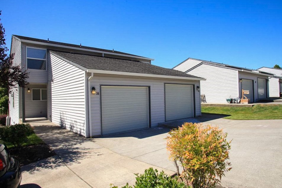 a white house with a garage and a driveway