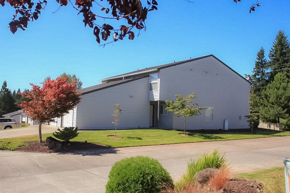 a large white building with a street in front of it