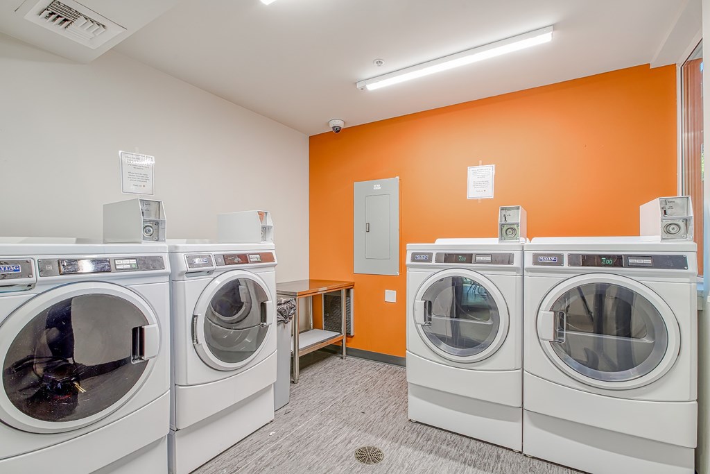 A row of washing machines in a laundromat.