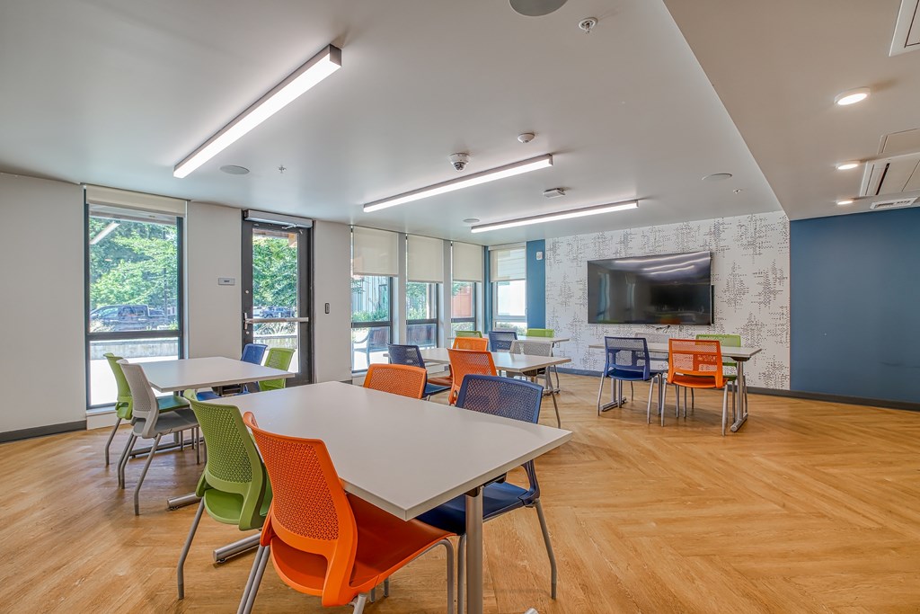 A conference room with a long table and chairs.