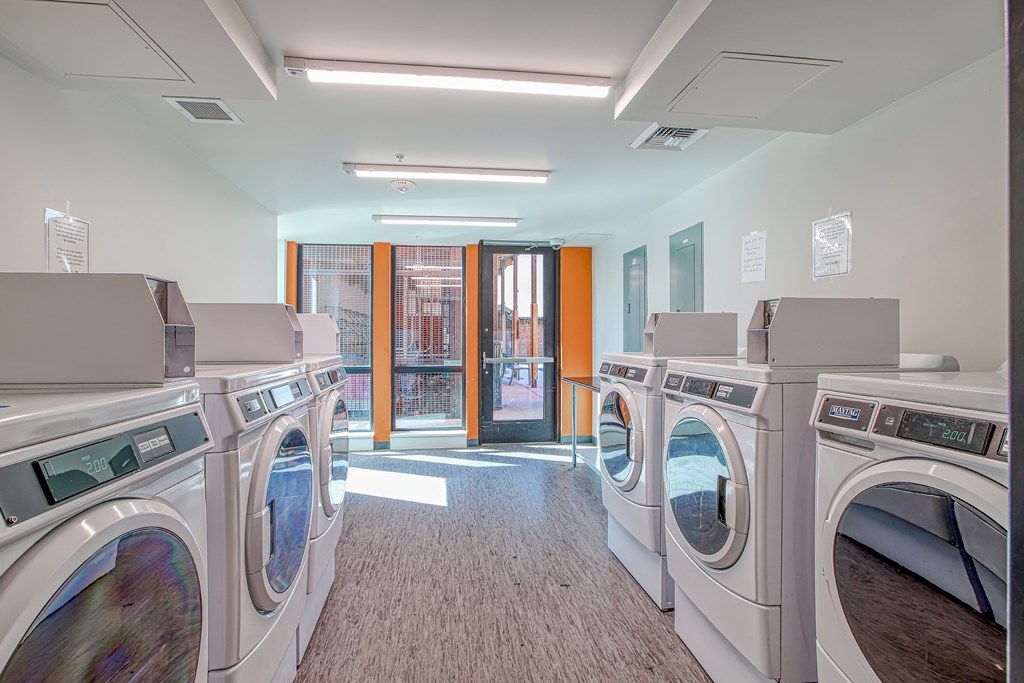 A row of washing machines in a laundromat.
