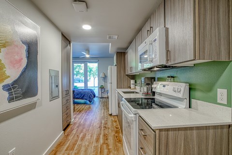 A kitchen with a stove top oven and a microwave above it.