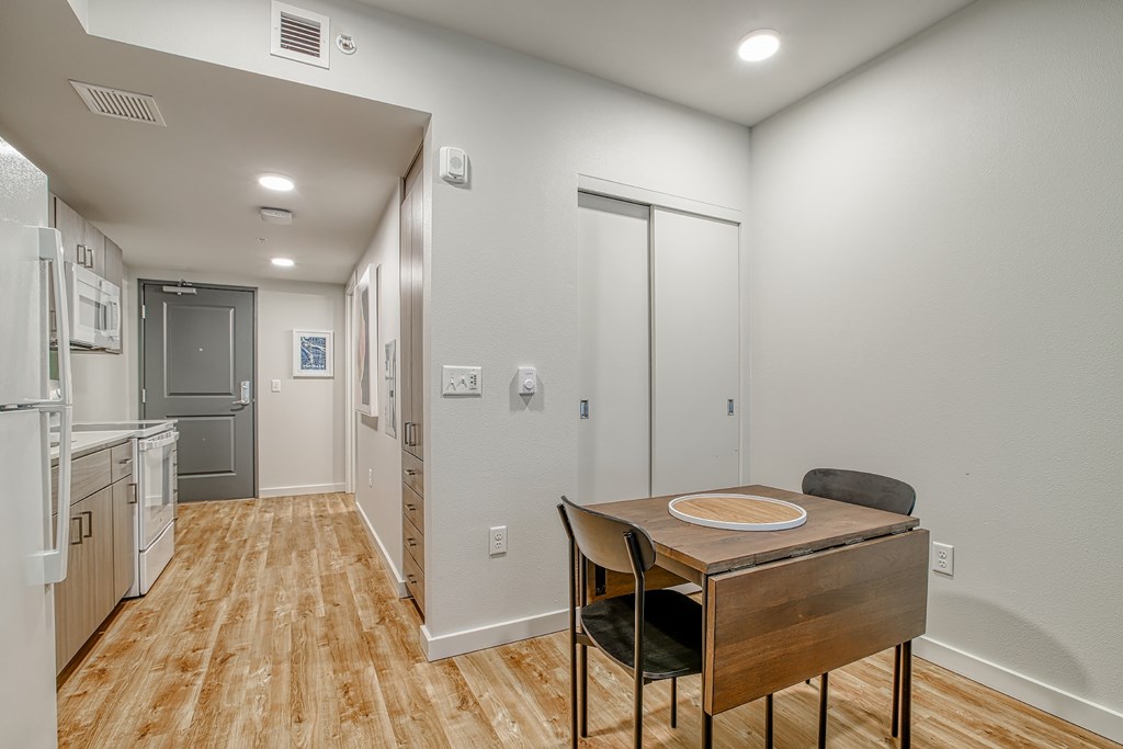 A kitchen with a table and chairs in the middle of the room.