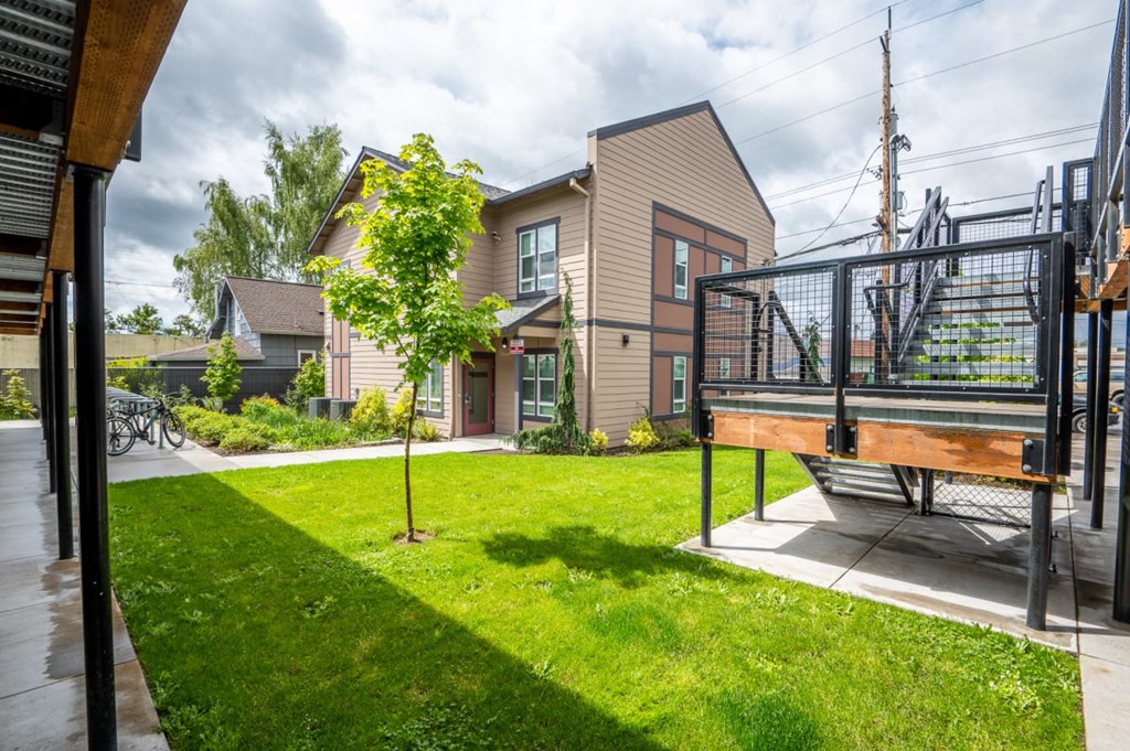 the back yard of a house with a deck and a staircase