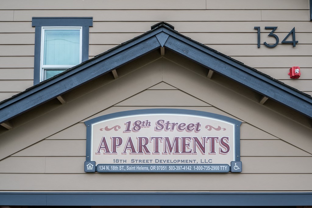 a sign for 18th street apartments on the side of a building