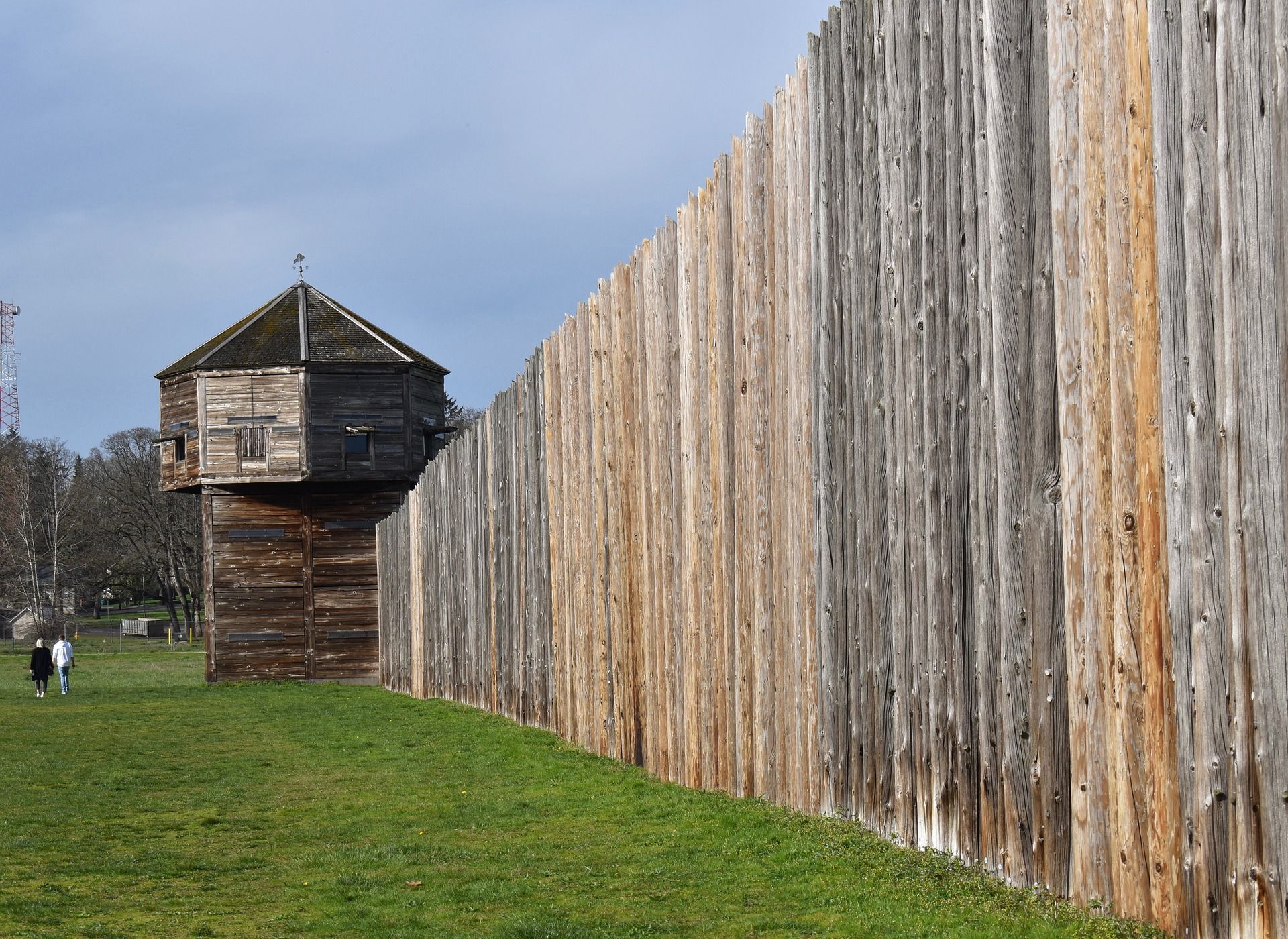 a wooden fence with a wooden observation tower behind it