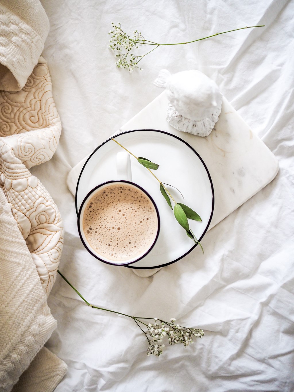 a cup of coffee with a flower on a plate