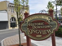 a sign for historic downtown longview on a city street