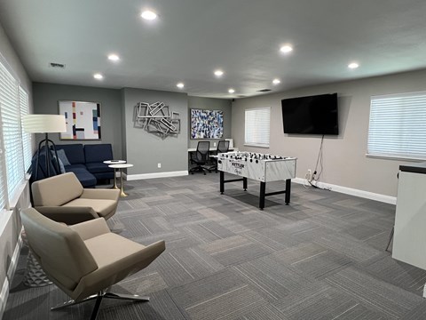 A room with grey carpeting and a white table with a sign that says "VETERINARY" on it.