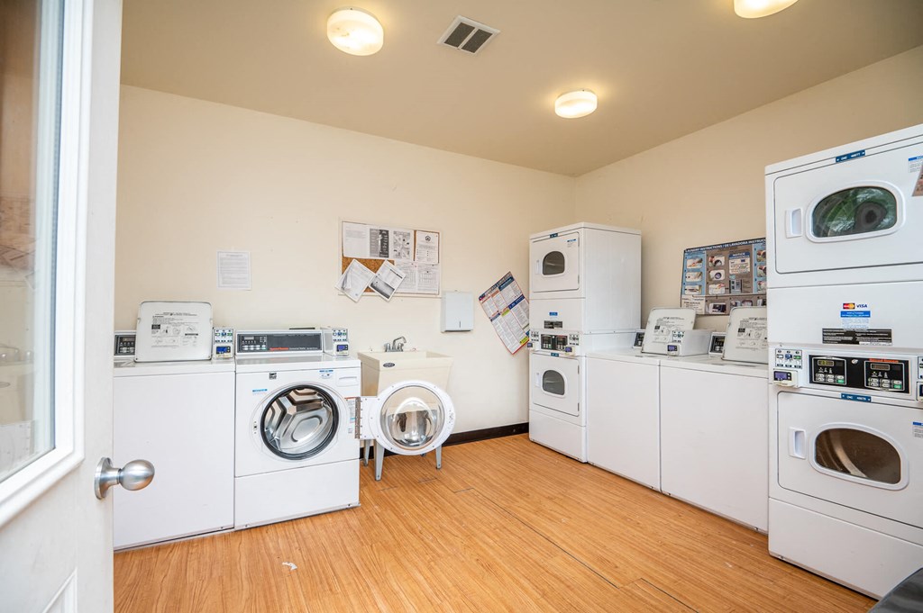 a laundry room with washer and dryers and washing machines