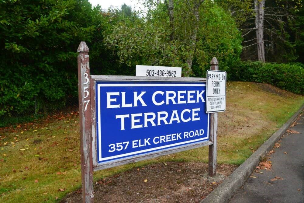 a sign for elk creek terrace at the side of a road
