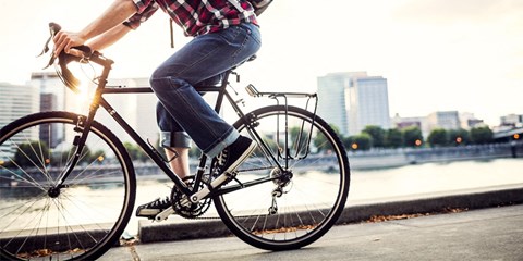 A person is riding a bicycle on a city street.
