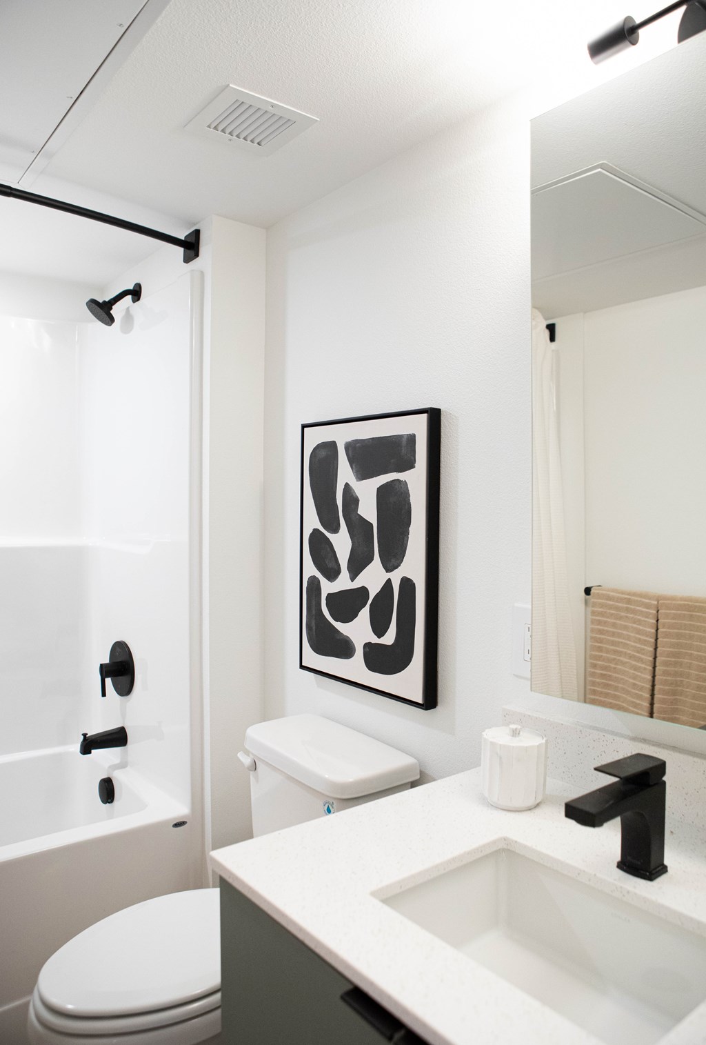 A white toilet sits next to a white sink in a bathroom.