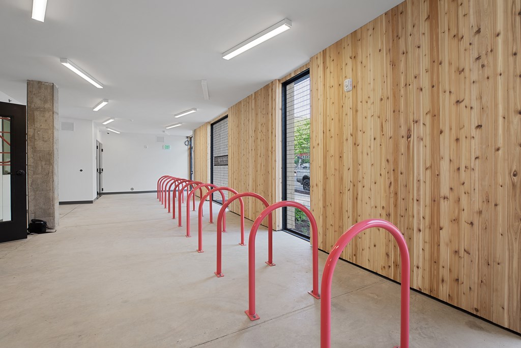 A long hallway with red handles on the wall.