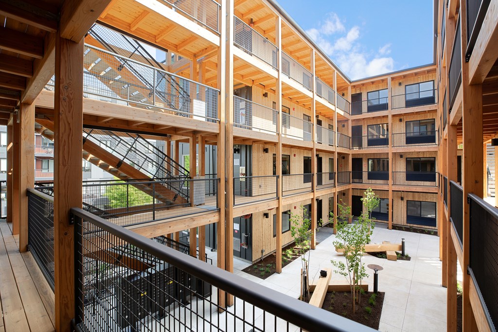 A view of a courtyard from a second floor balcony.