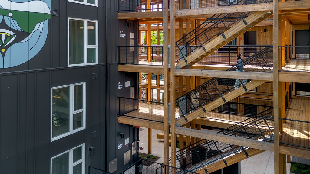 A person is walking up a wooden staircase.