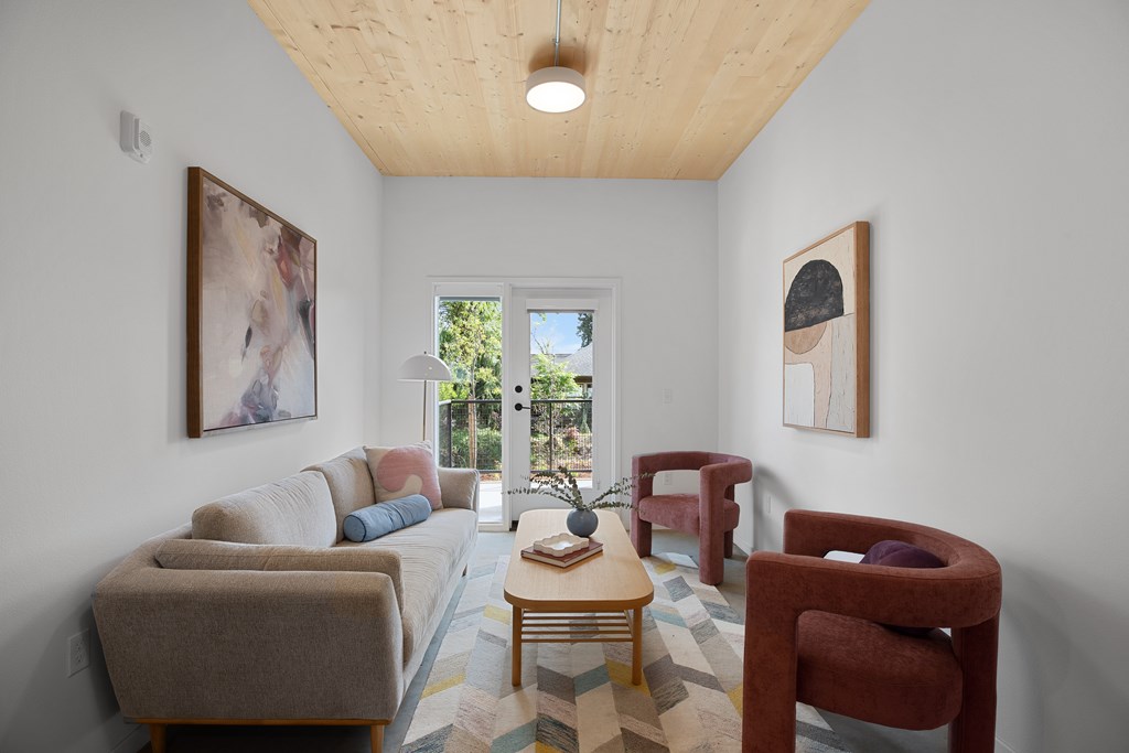 A living room with a couch, chairs, and a coffee table.