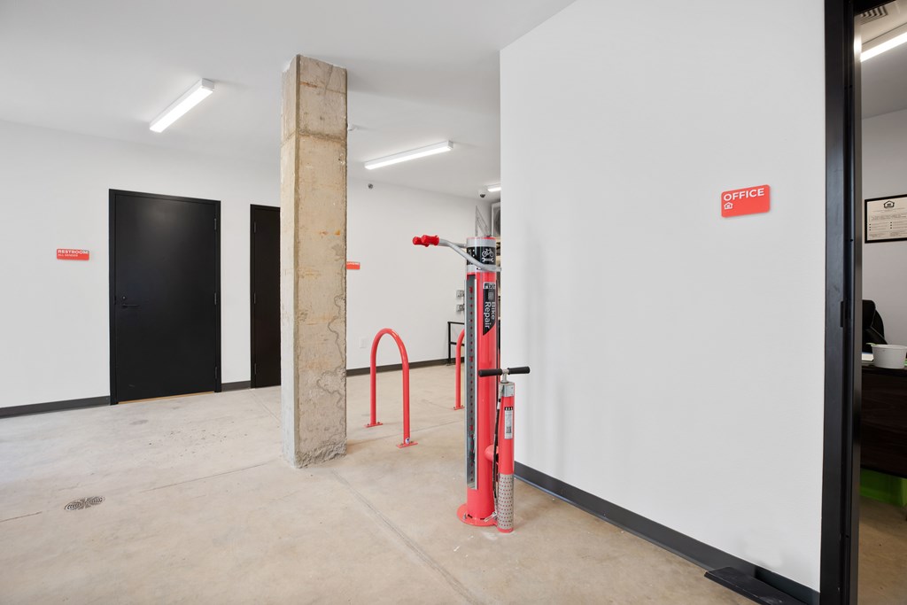 A white wall with a red sign that says "OFFICE" on it.