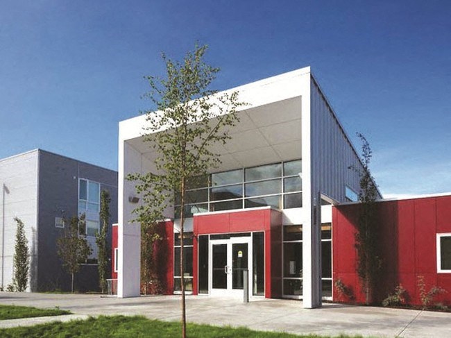 a photo of a building with red doors