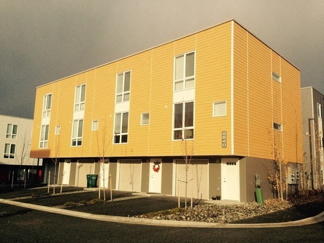 a large yellow building with a gray sky in the background