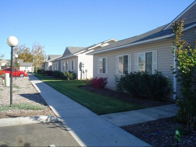 a white house with a sidewalk in front of it