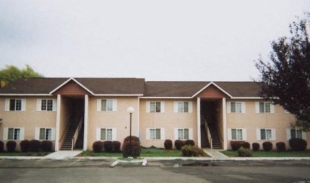 an apartment building with a street in front of it