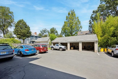 A parking lot with cars and a building in the background.