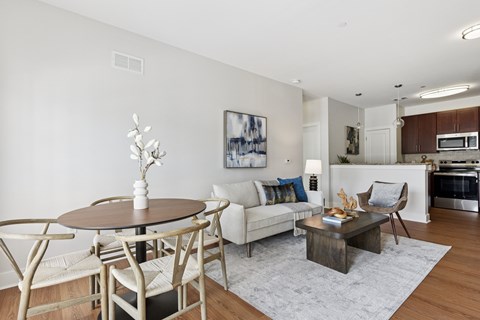 A modern living room with a dining table and chairs.