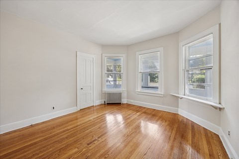 A room with wooden floors and white walls.