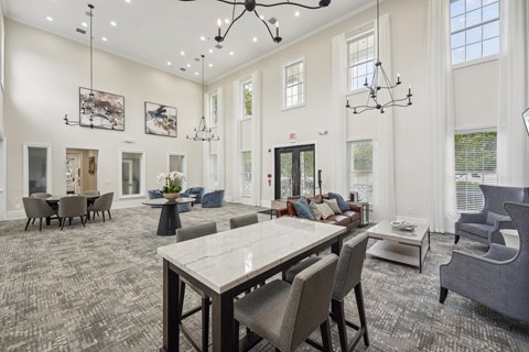 A large dining room with a long table and chairs.