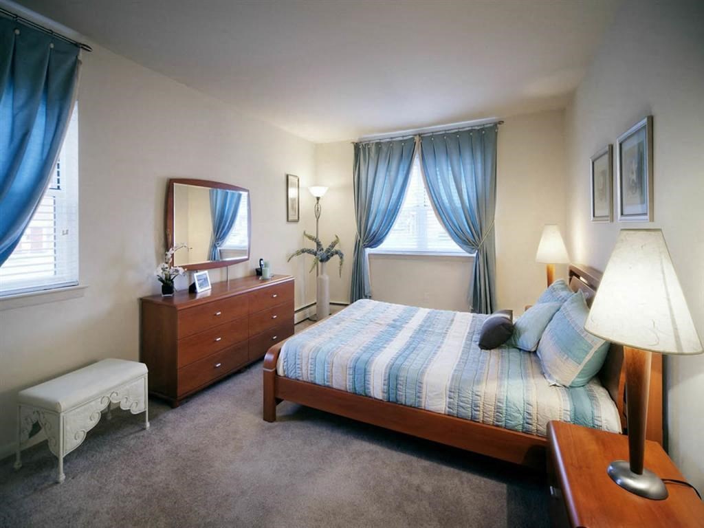 a bedroom with a bed and a dresser