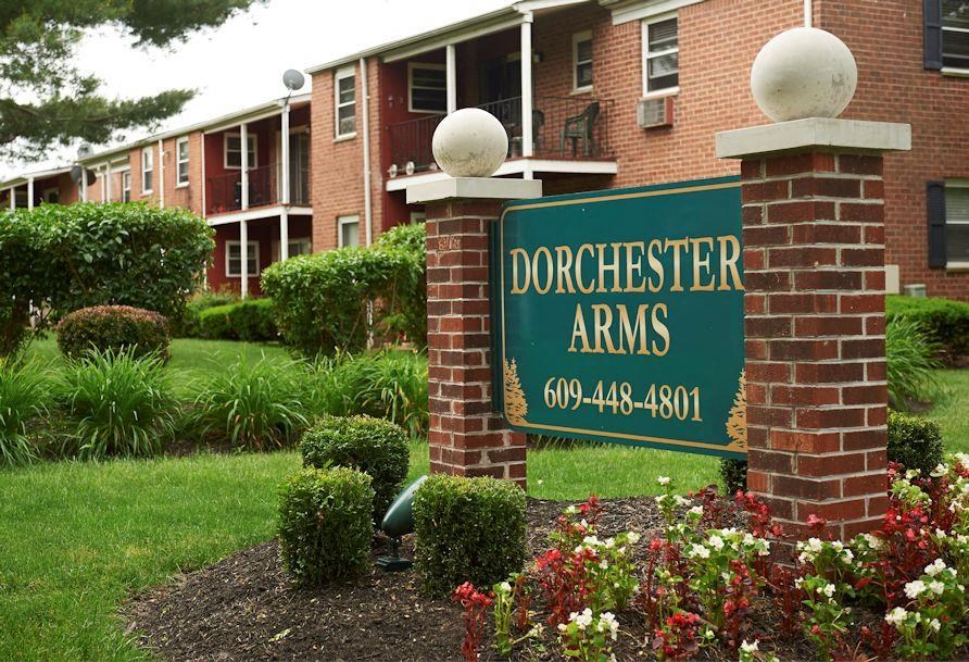 a sign for dorchester arms in front of a building