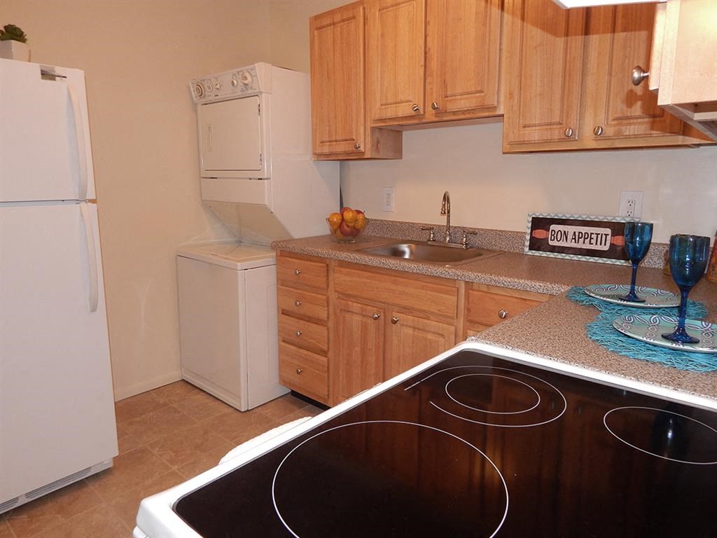 a kitchen with white appliances and wooden cabinets